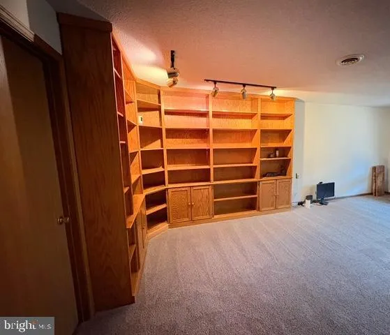 a view of a yard with wooden fence