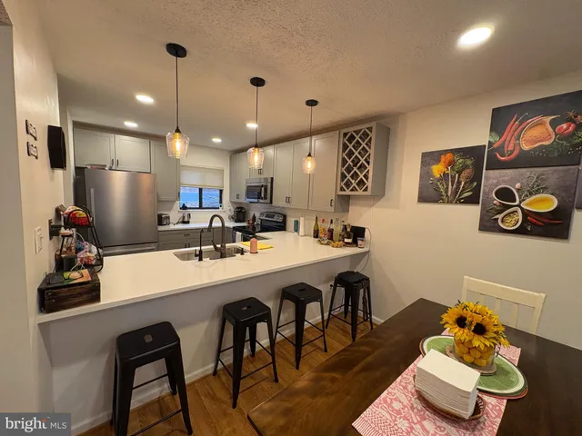 a large kitchen with a table and chairs
