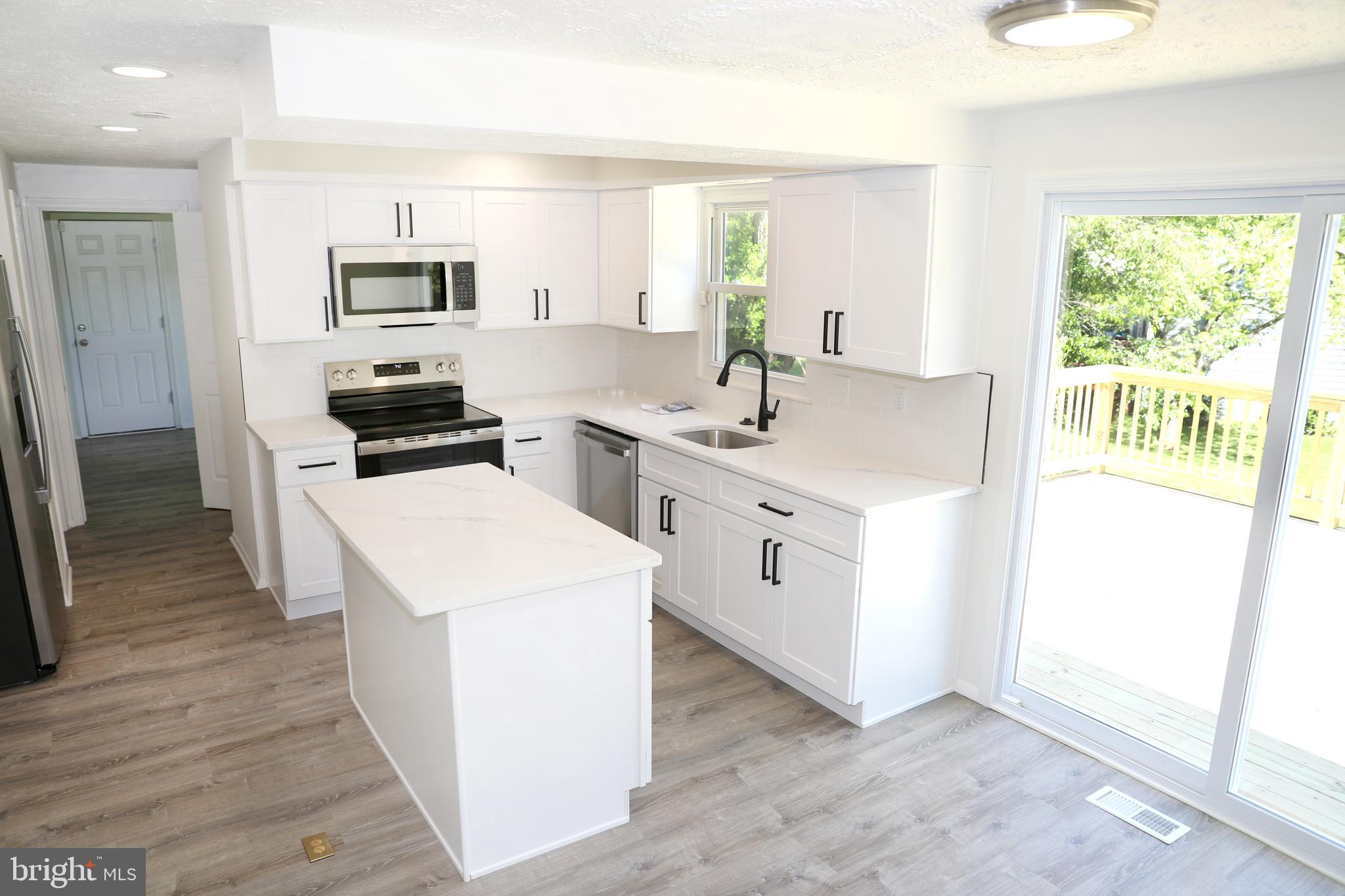 8106 Triple Crown Road Bowie, MD 20715 - Photo 2 of 21 a kitchen with white cabinets and sink