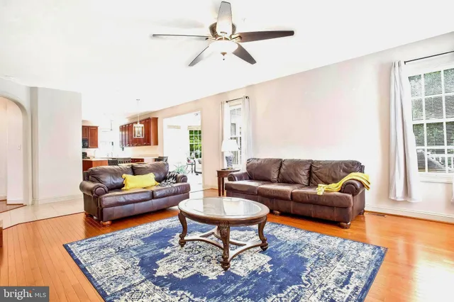 a living room with furniture rug and wooden floor
