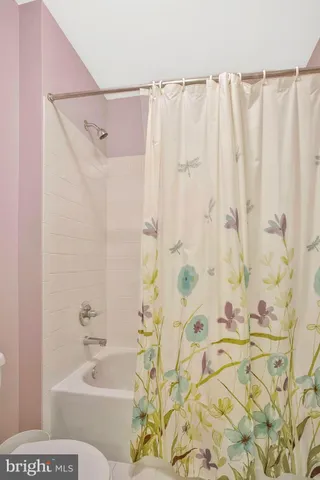 a view of walk in closet with clothes