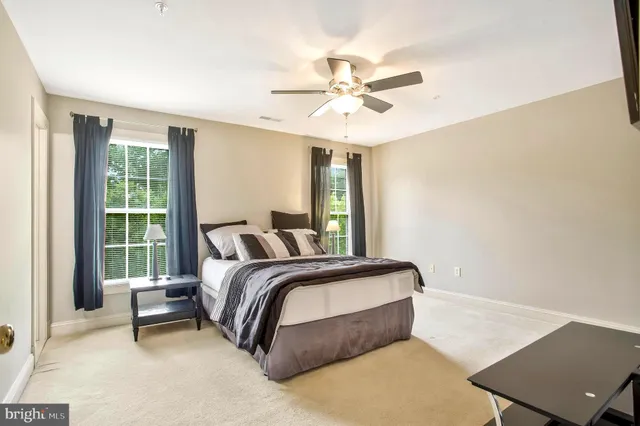 a spacious bathroom with double vanity sink a mirror a bathtub and next to a window