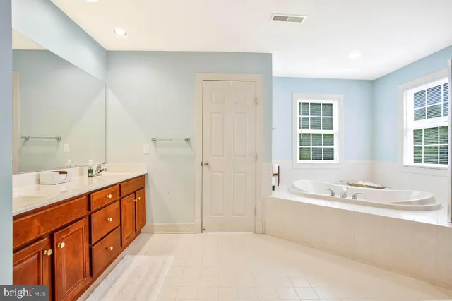 a bathroom with a sink toilet a mirror and shower