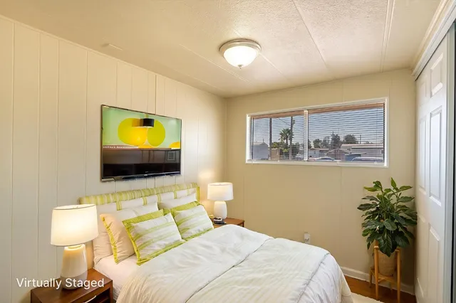 a bedroom with a bed and a flat screen tv