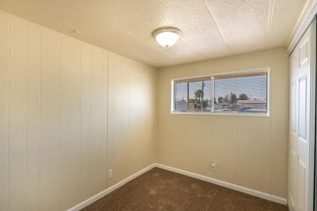 a room with painting on the wall and a window