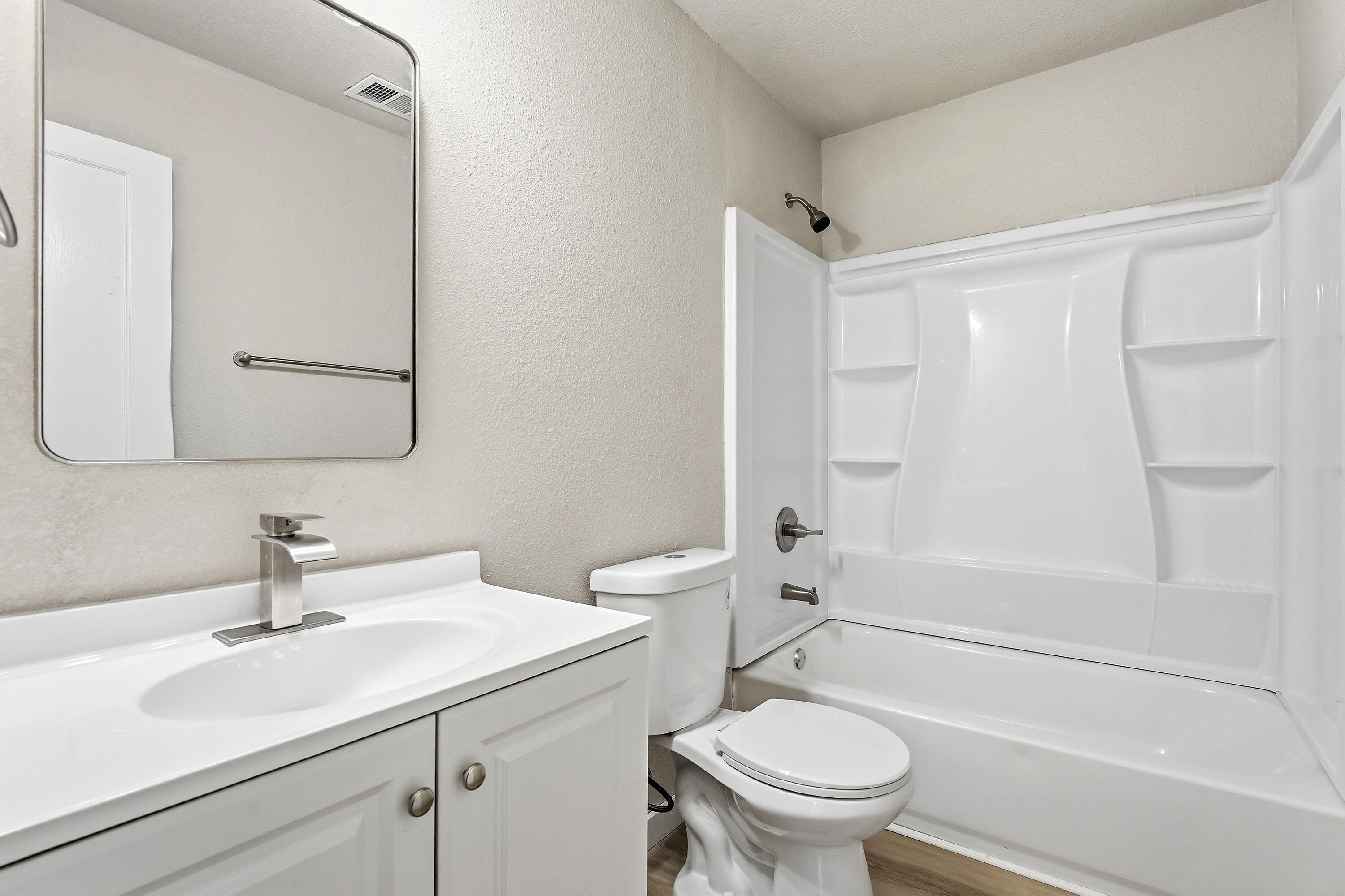 2814 40th Street Lubbock, TX 79413 - Photo 9 of 11 a bathroom with a sink toilet vanity and shower