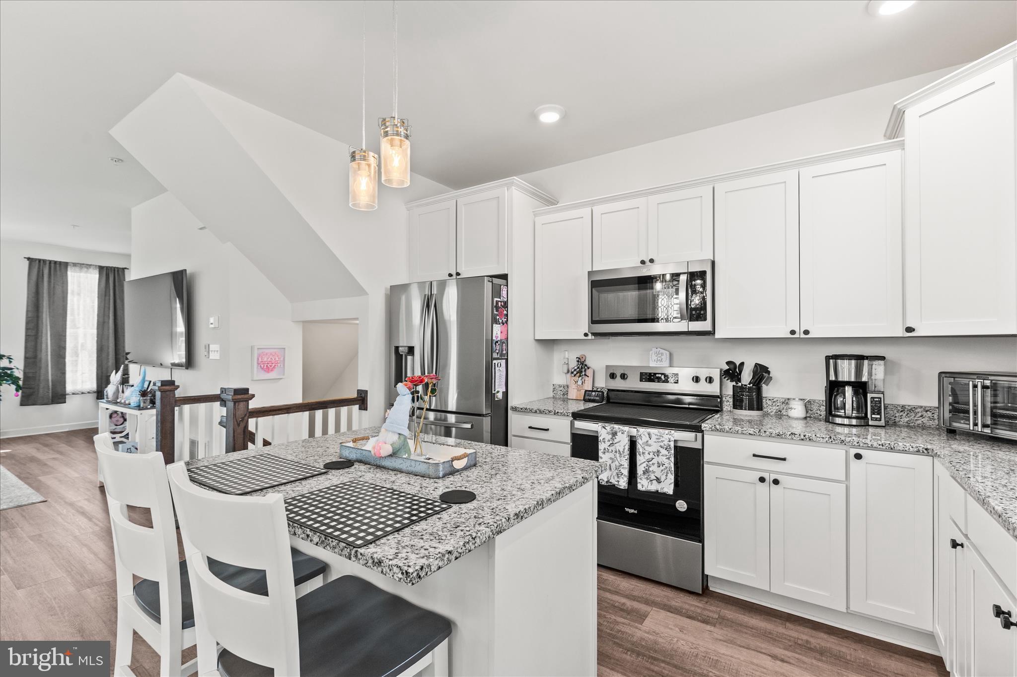 101 Overlook Dr. Hanover, PA 17331 - Photo 14 of 38 a kitchen with stainless steel appliances kitchen island granite countertop a stove a sink dishwasher a refrigerator and white cabinets with wooden floor