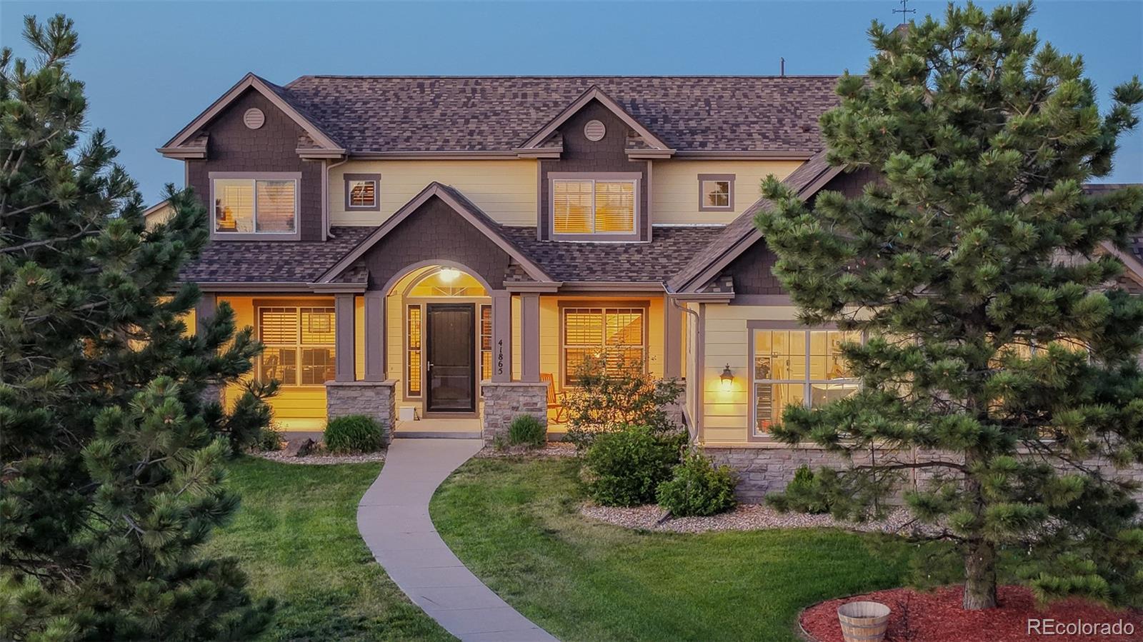 41865 East Muirfield Loop Elizabeth, CO 80107 - Photo 4 of 50 a front view of a house with garden