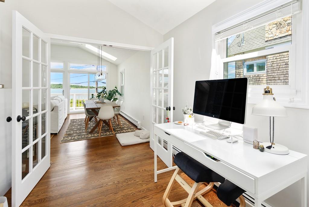 5 Beach Lane Hingham, MA 02043 - Photo 12 of 32 a living room with furniture a flat screen tv and a large window