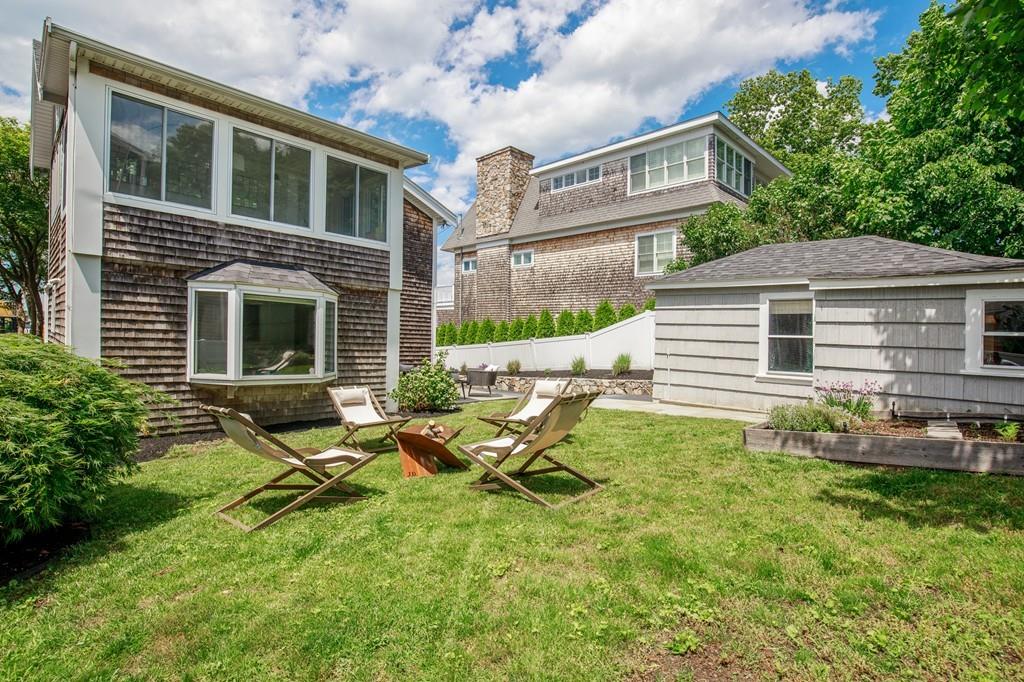 5 Beach Lane Hingham, MA 02043 - Photo 23 of 32 a backyard of a house with table and chairs