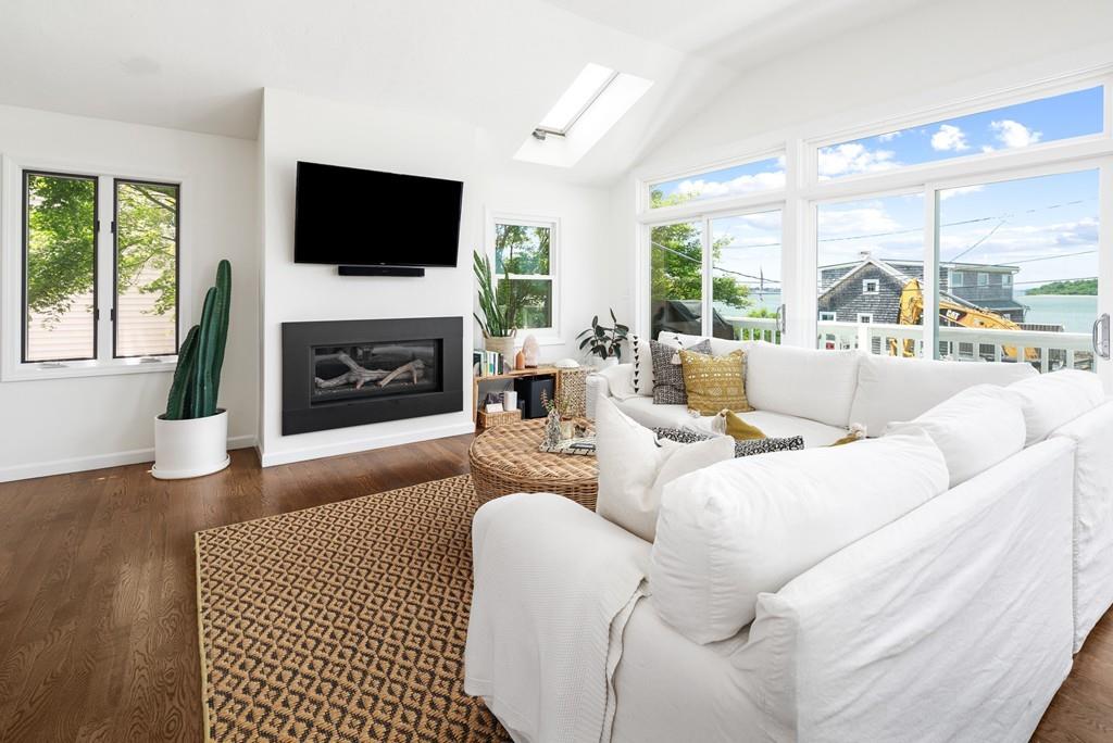 5 Beach Lane Hingham, MA 02043 - Photo 7 of 32 a living room with furniture a fireplace and a flat screen tv