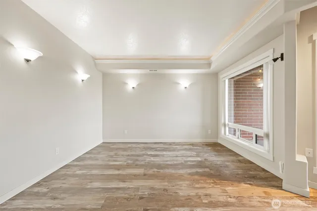 a view of empty room with wooden floor