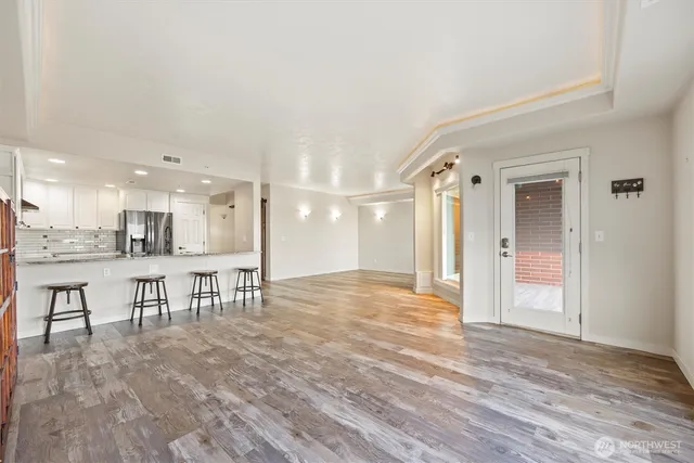 a view of a room with wooden floor and mountain view