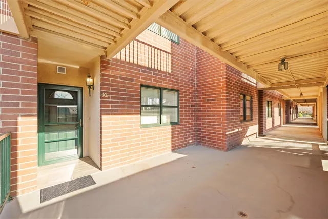 a view of a brick house with many windows