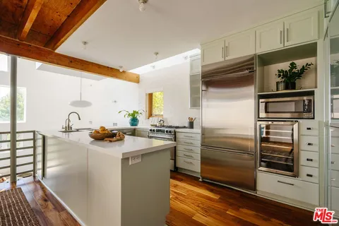 a kitchen with refrigerator and cabinets