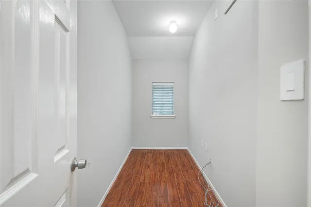 a spacious bathroom with a toilet a sink and a mirror