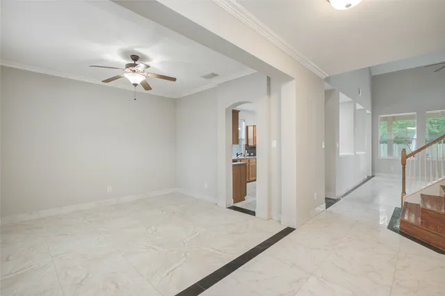 an empty room with fan and windows