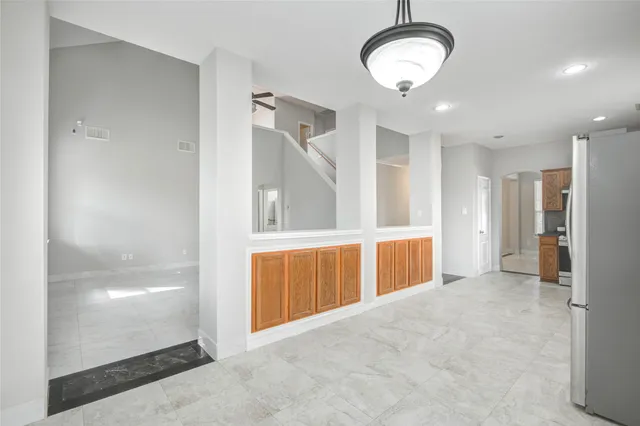 a view of a room with wooden floor and window