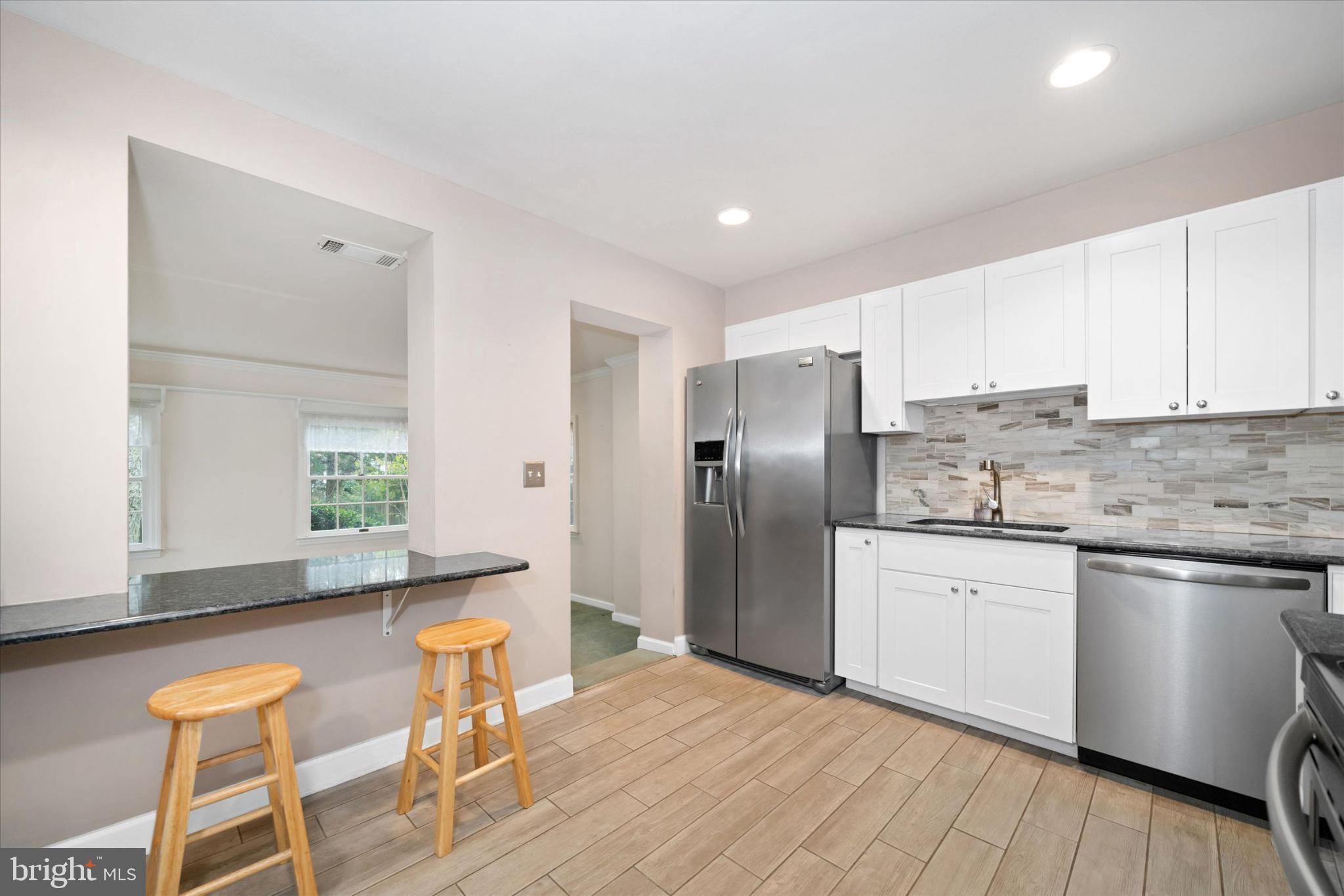 42 Paschall Road Wilmington, DE 19803 - Photo 12 of 41 a kitchen with stainless steel appliances granite countertop a refrigerator and a stove top oven