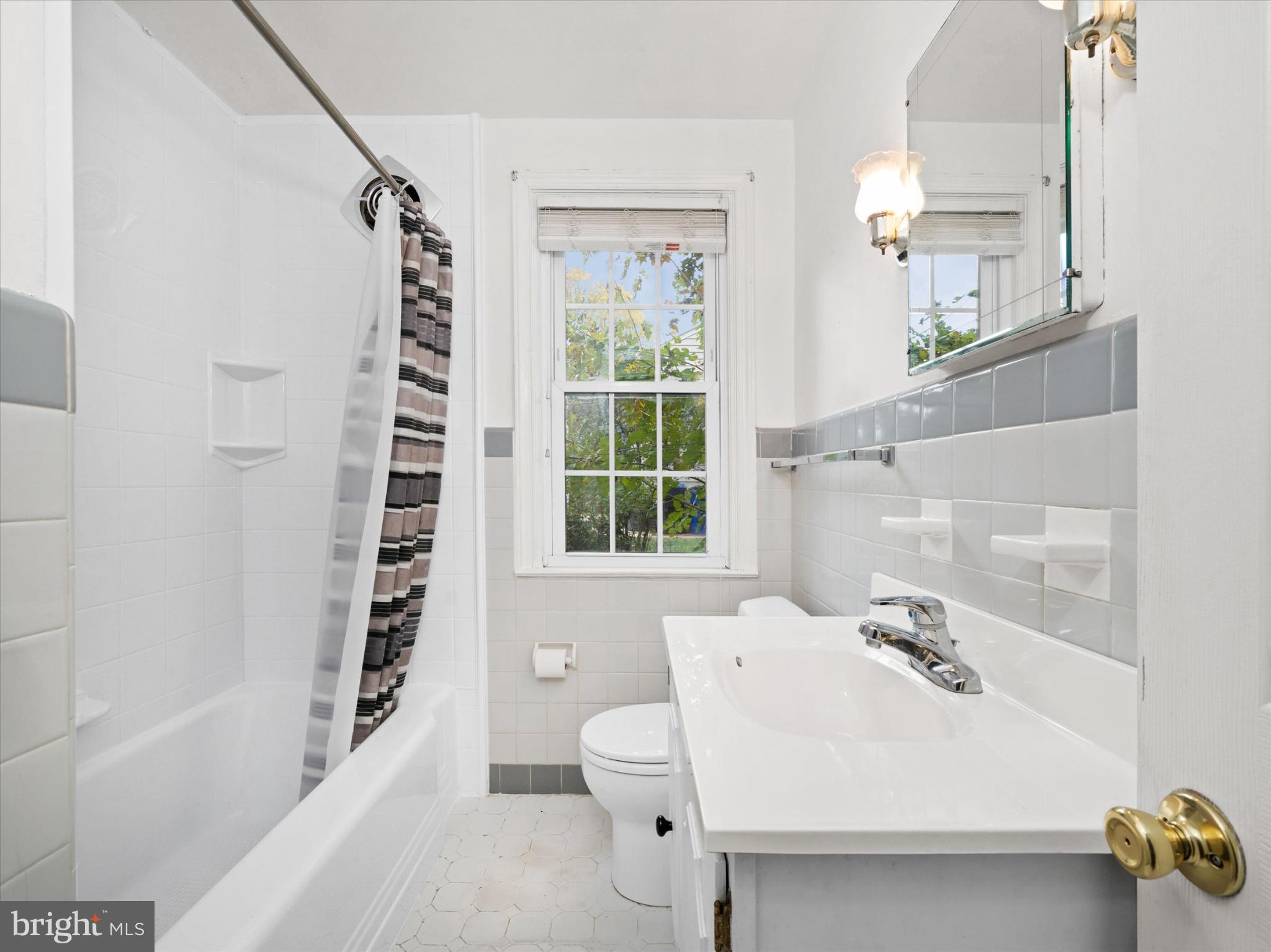 42 Paschall Road Wilmington, DE 19803 - Photo 21 of 41 a bathroom with a sink a bathtub and next to a window