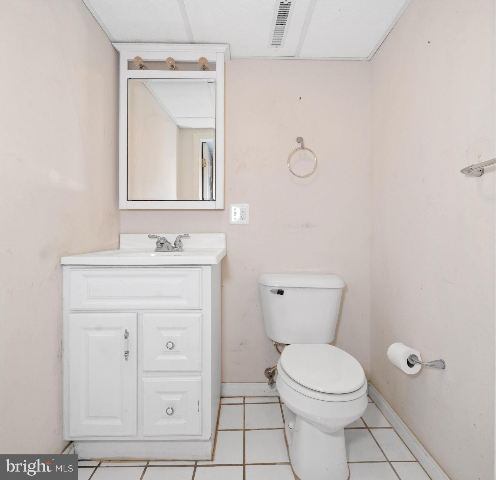 42 Paschall Road Wilmington, DE 19803 - Photo 33 of 41 a bathroom with a toilet a sink a mirror and vanity