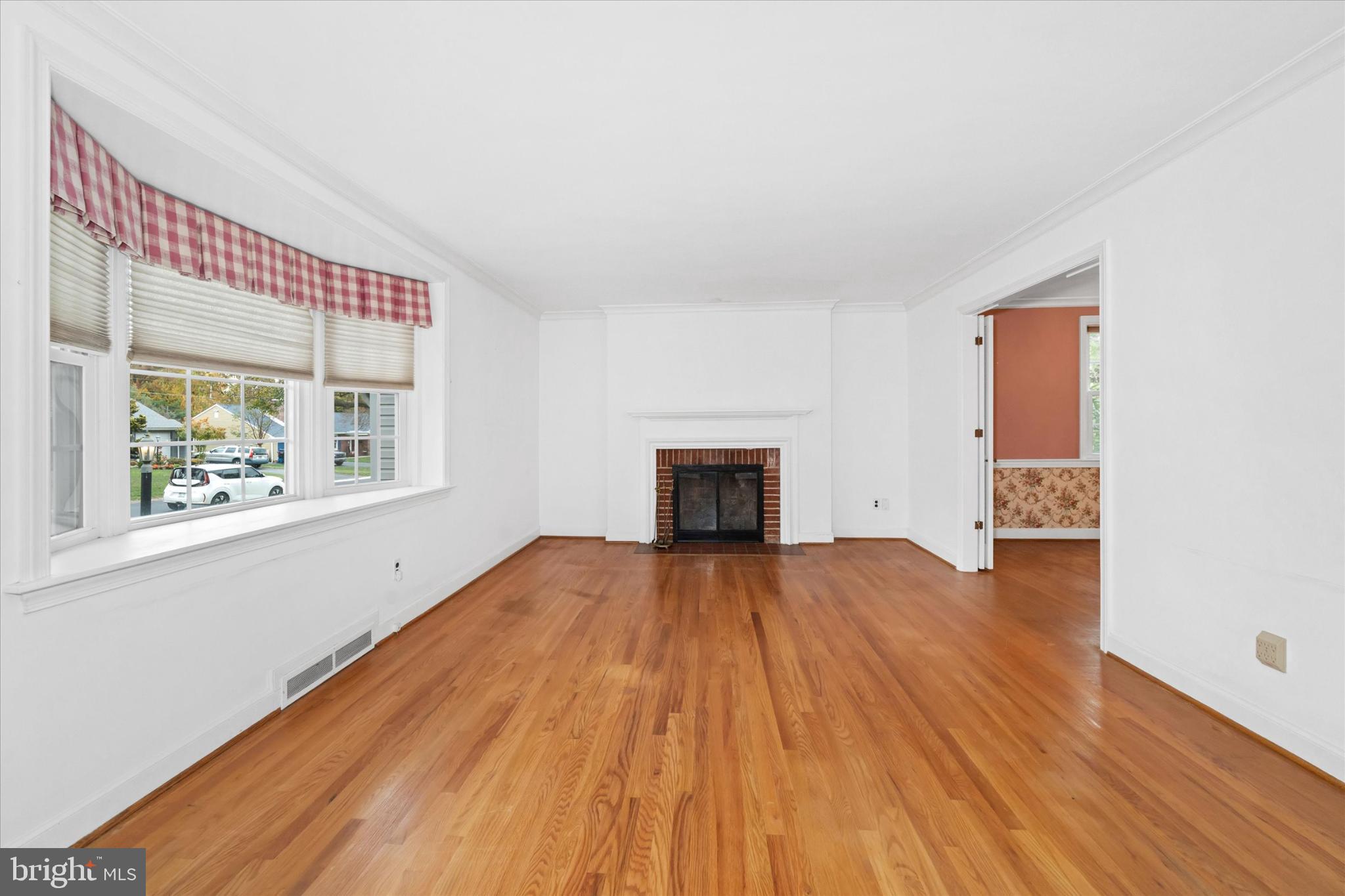 42 Paschall Road Wilmington, DE 19803 - Photo 4 of 41 a view of empty room with wooden floor and fireplace