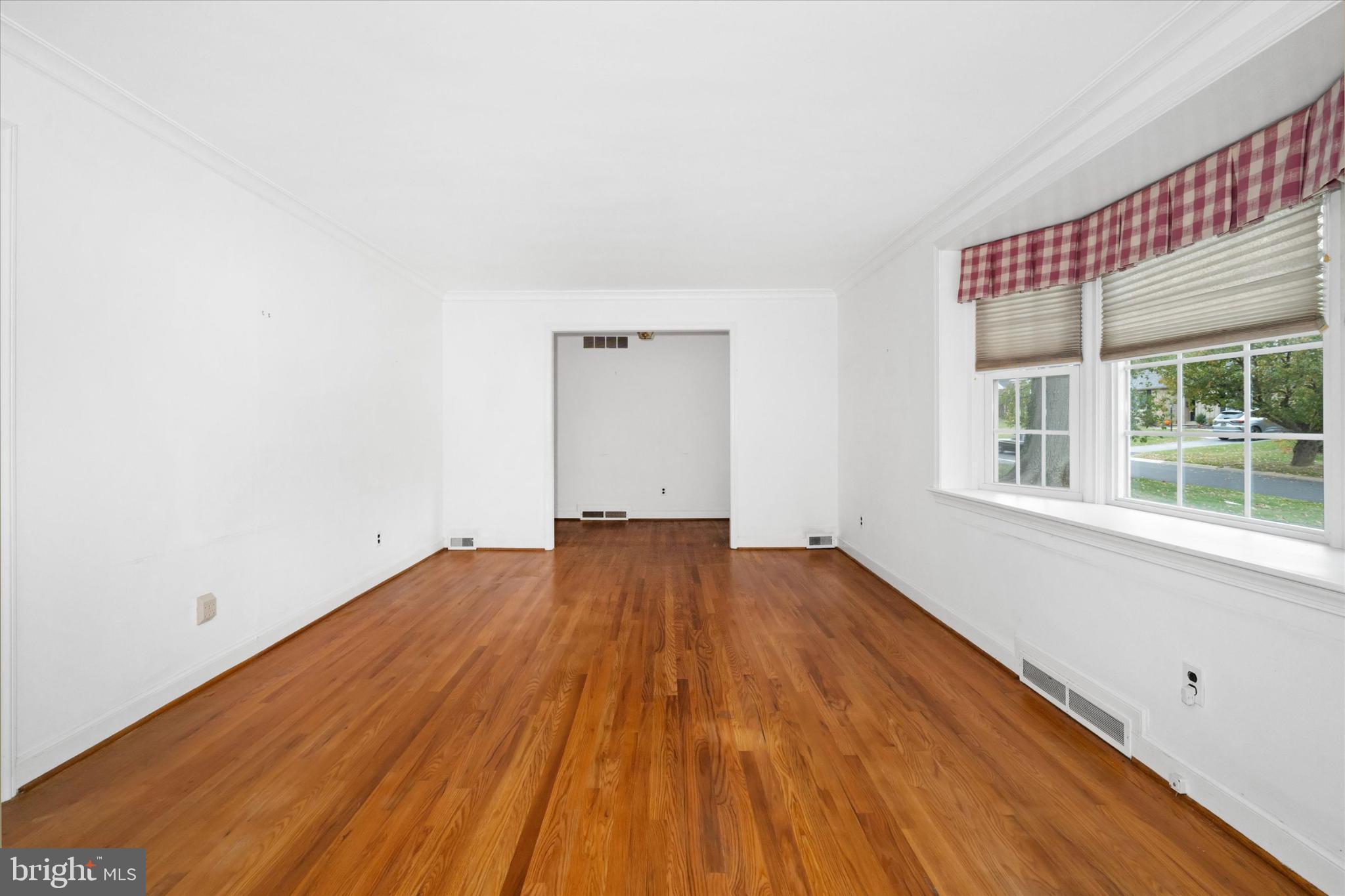 42 Paschall Road Wilmington, DE 19803 - Photo 5 of 41 an empty room with wooden floor and windows