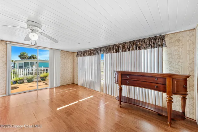 a view of a room with wooden floor