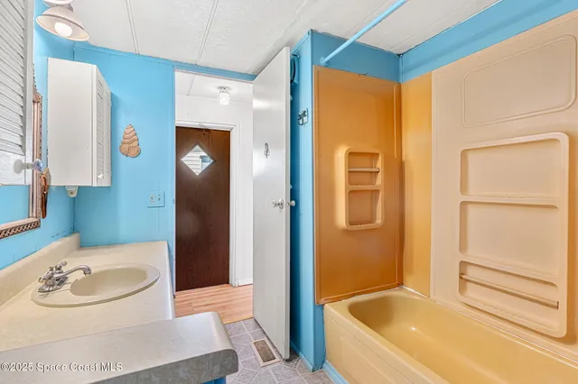 a bathroom with a tub and a sink