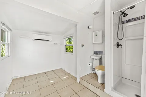 a bathroom with a toilet and a shower