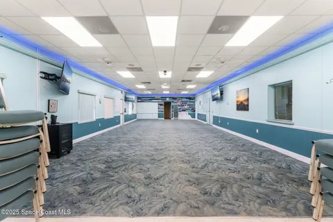 a view of a livingroom with furniture and a kitchen
