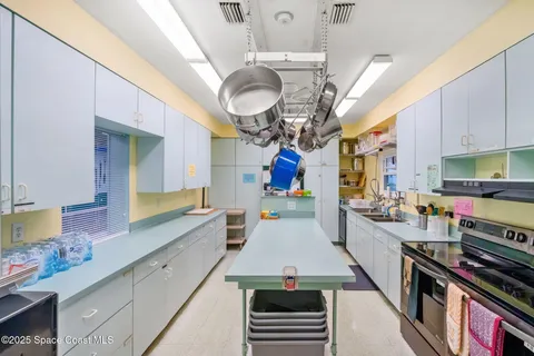 a kitchen with lots of counter top space appliances and cabinets