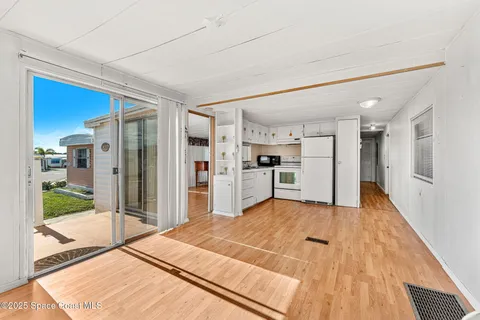 a open kitchen with stainless steel appliances granite countertop a refrigerator and a sink