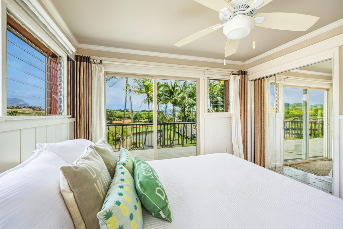 5061 Lawai Road, Unit 402 Koloa, HI 96756 - Photo 11 of 30 a bedroom with a bed and a large window