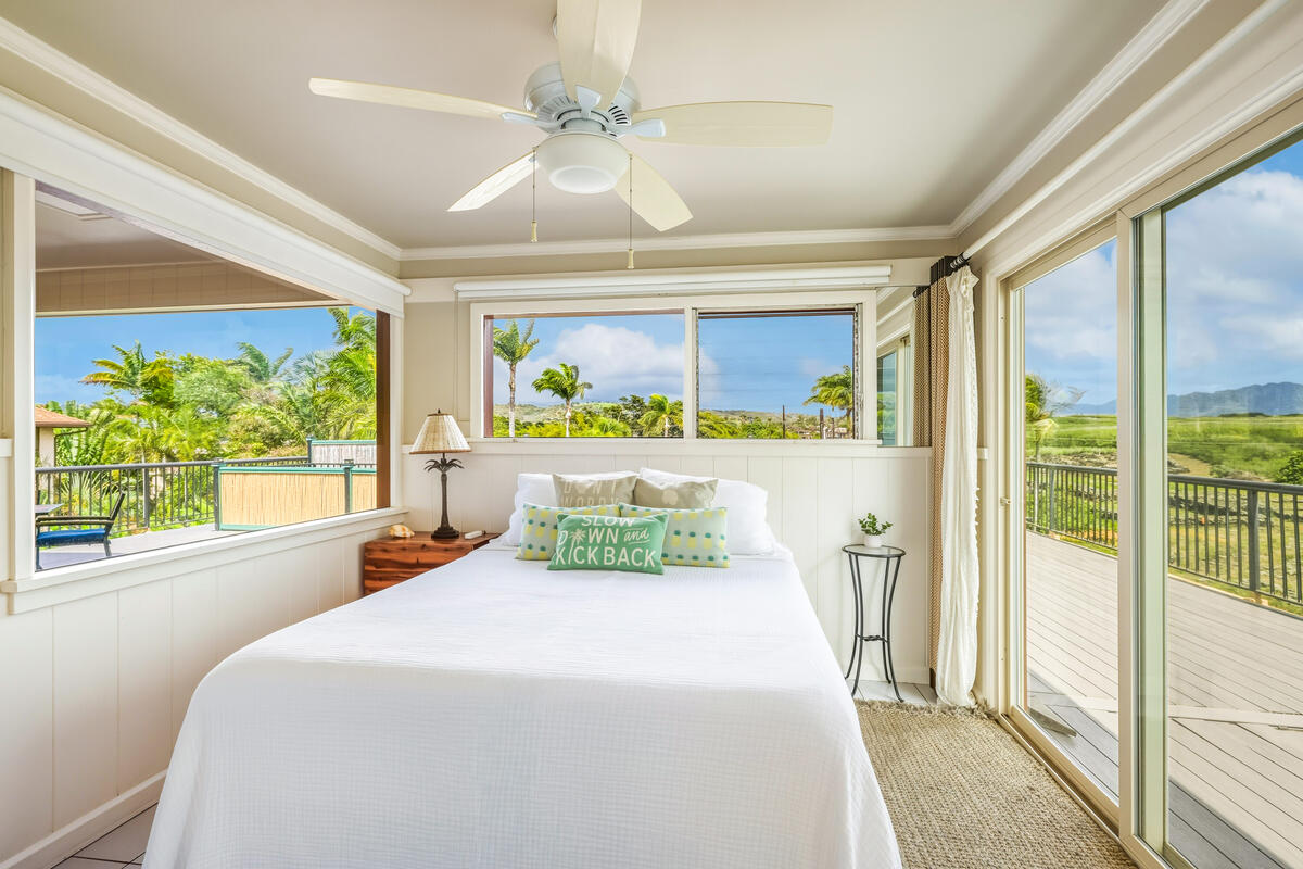 5061 Lawai Road, Unit 402 Koloa, HI 96756 - Photo 12 of 30 a bedroom with a large bed and a large window with outer view