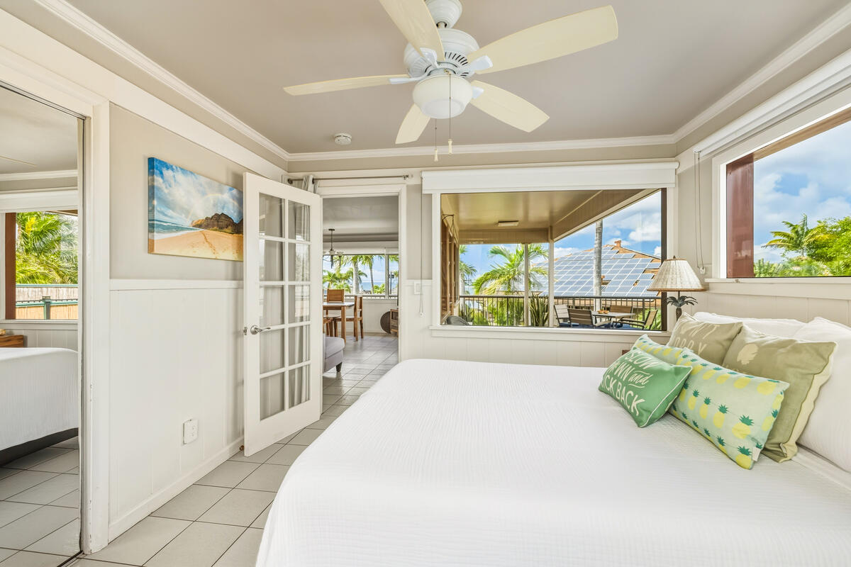 5061 Lawai Road, Unit 402 Koloa, HI 96756 - Photo 13 of 30 a spacious bedroom with a balcony a bed and a large window