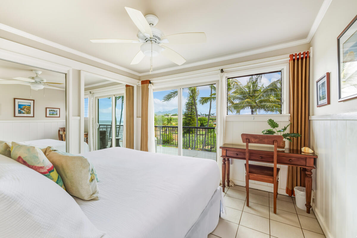 5061 Lawai Road, Unit 402 Koloa, HI 96756 - Photo 15 of 30 a bedroom with a bed and a large window