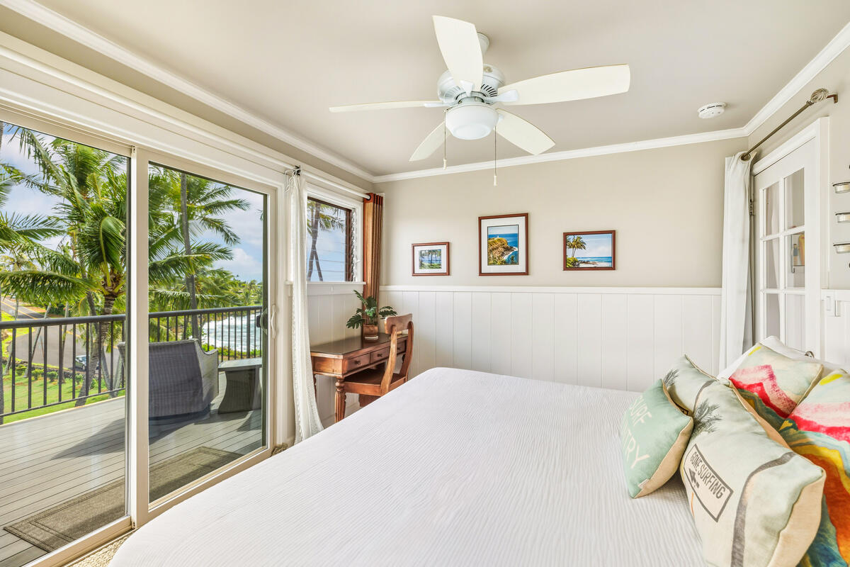 5061 Lawai Road, Unit 402 Koloa, HI 96756 - Photo 17 of 30 a bedroom with a bed and a chandelier