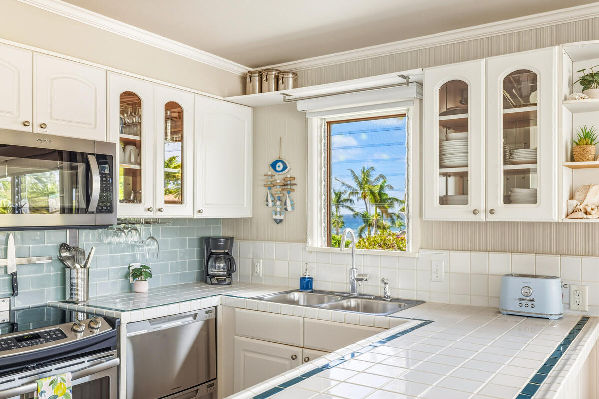 5061 Lawai Road, Unit 402 Koloa, HI 96756 - Photo 8 of 30 a kitchen with a sink a stove and cabinets