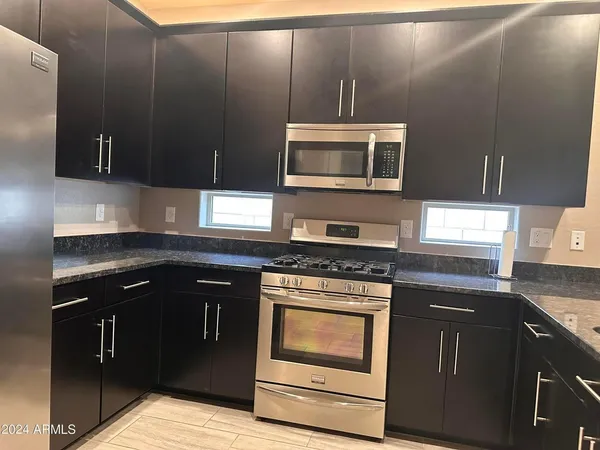 a kitchen with a stove and a microwave