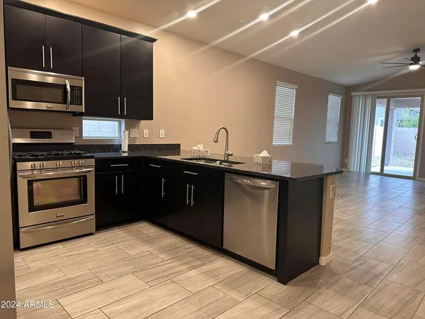 a kitchen with a sink stove and microwave