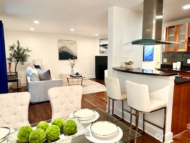 a living room with kitchen island furniture and a chandelier