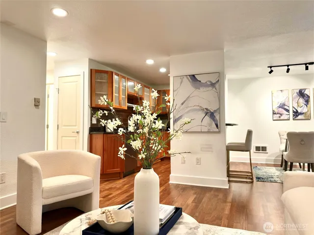 a living room with furniture and wooden floor