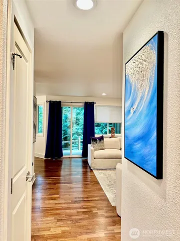 a view of a living room with furniture and floor to ceiling windows