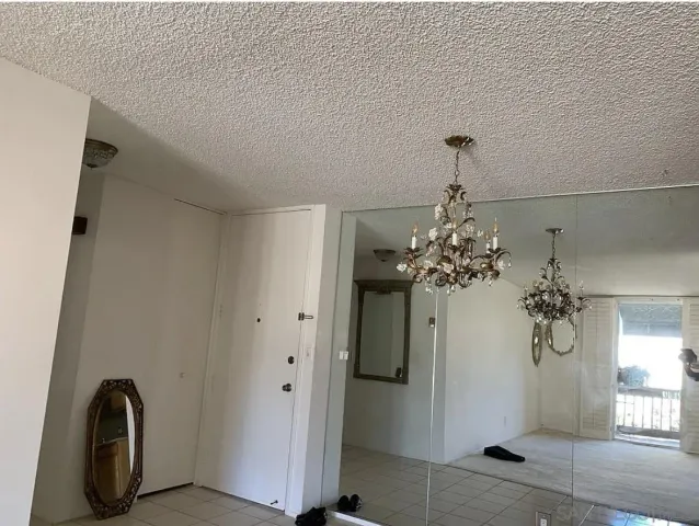 a view of a room with chandelier fan and wooden floor