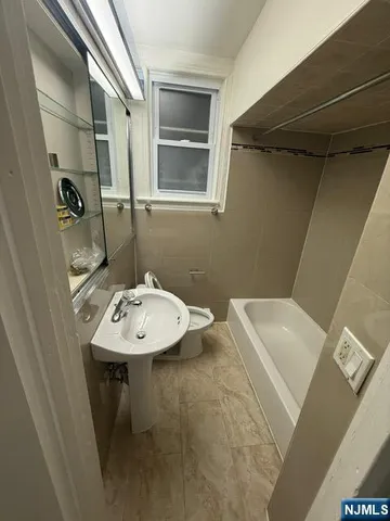 a bathroom with a sink a toilet and mirror