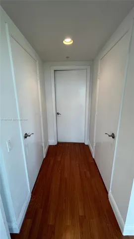 a view of hallway with wooden floor