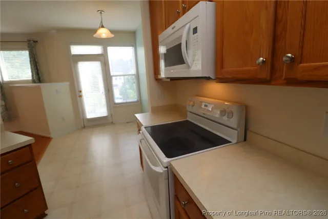 a kitchen with a sink stove and a mirror