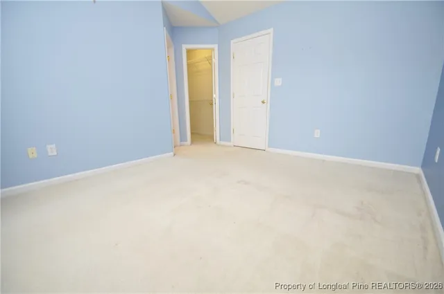 a spacious bathroom with a double vanity sink a mirror and a bathtub