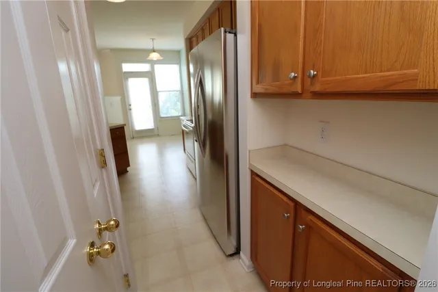 a kitchen with a sink a window and cabinets